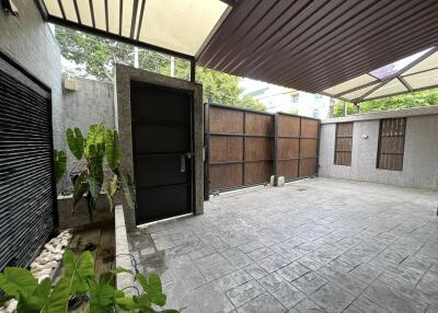 Covered garage with secure door and plants