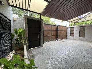 Covered garage with secure door and plants