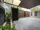 Covered garage with secure door and plants