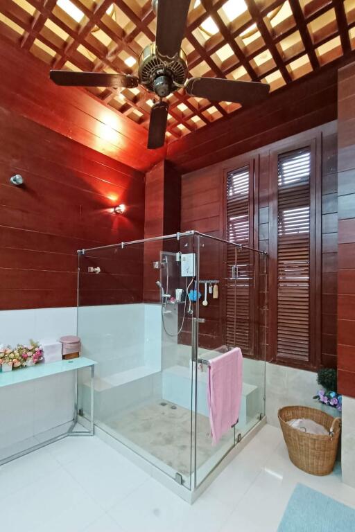 Modern bathroom with a glass-enclosed shower and wooden ceiling