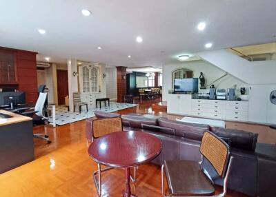 Modern living area with wooden flooring and ample lighting