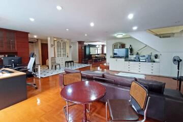 Modern living area with wooden flooring and ample lighting