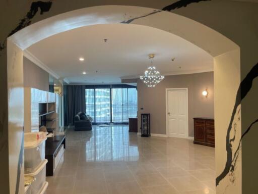 Spacious living room with modern chandelier and large windows