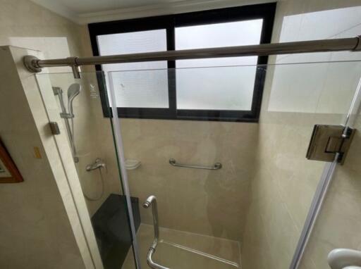 Modern bathroom shower with glass door and window