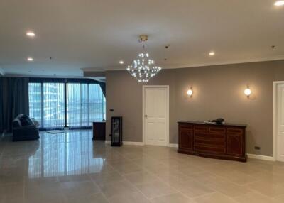 Spacious living room with chandelier and large windows