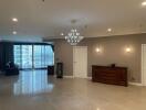 Spacious living room with chandelier and large windows