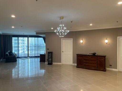 Spacious living room with chandelier and large windows