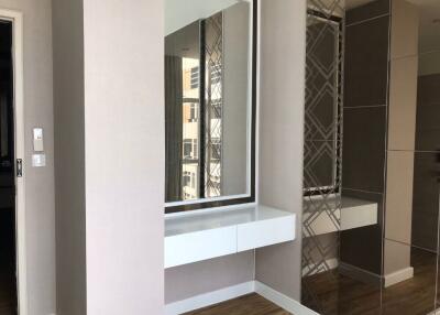 Bedroom with built-in vanity and mirrored wardrobe