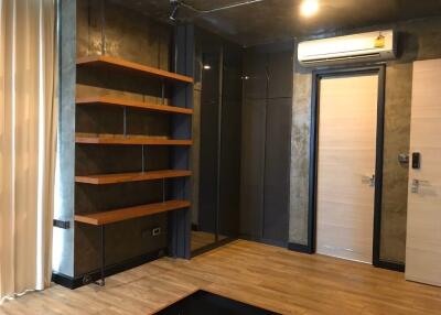 Living room with wooden shelves and air conditioning unit