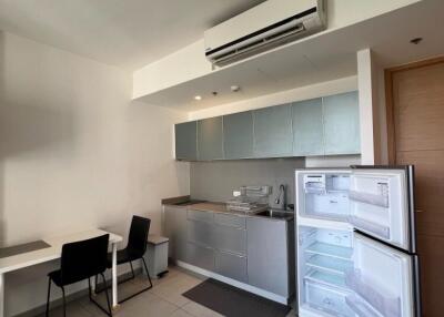 Modern kitchen with table, chairs, and open refrigerator