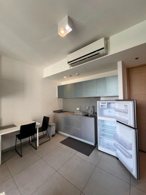 Modern kitchen with table, chairs, and open refrigerator