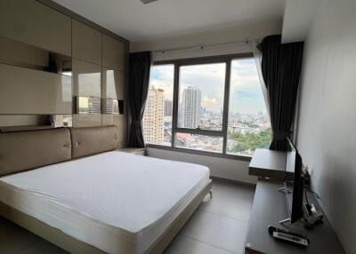 Spacious and modern bedroom with a large window view