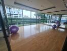 Spacious fitness room with large windows and yoga balls