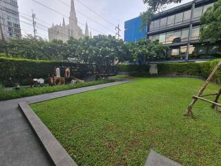 Well-maintained grassy backyard with children