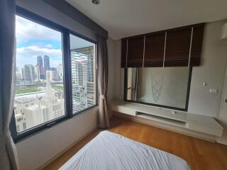 Spacious bedroom with large window and city view