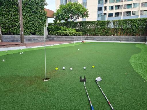 Outdoor putting green with golf clubs