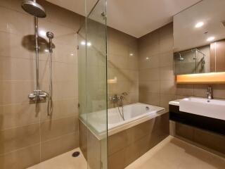 Modern bathroom with a glass-enclosed shower and bathtub combination