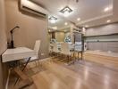 Modern dining area with white chairs, table, and kitchen in the background