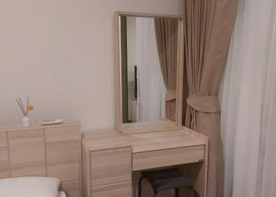 Bedroom with vanity and mirror