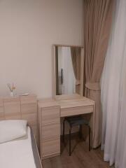 Bedroom with vanity and mirror