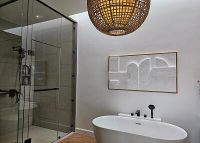 Modern bathroom with glass shower and freestanding bathtub