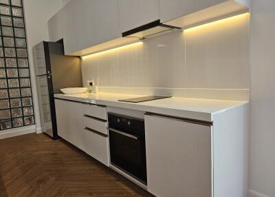 Modern kitchen with sleek white cabinets and built-in appliances