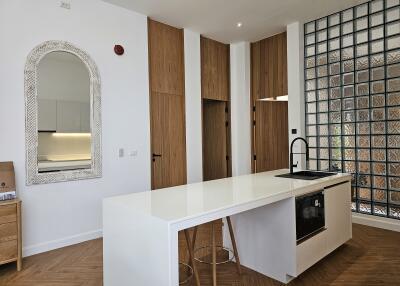 Modern kitchen with island and glass block wall