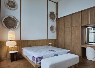 Modern bedroom with a large bed, wooden accents, and decorative elements