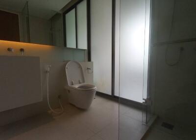 Modern bathroom with frosted glass and sleek fixtures