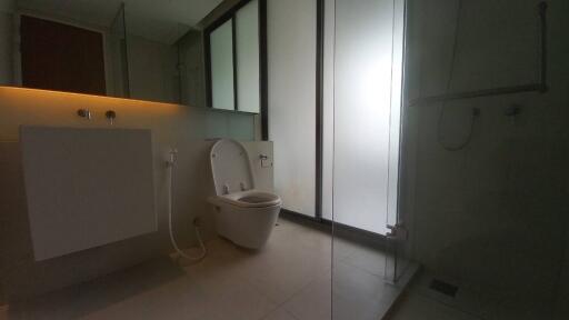 Modern bathroom with frosted glass and sleek fixtures