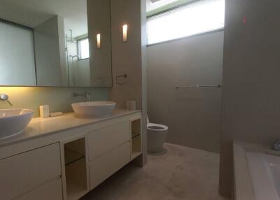 Modern bathroom with dual sinks and a bathtub