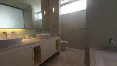 Modern bathroom with dual sinks and a bathtub