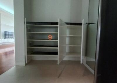 Partially constructed shelves and closet with wooden flooring