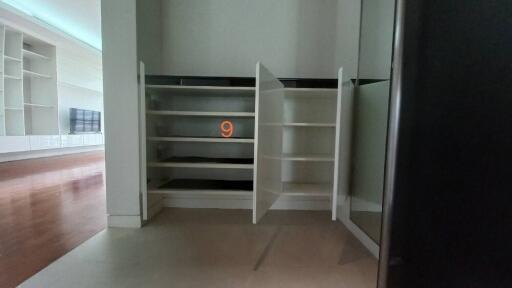 Partially constructed shelves and closet with wooden flooring