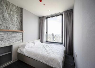 Modern bedroom with large window and city view