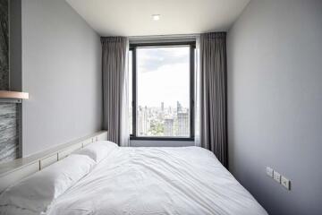 Bedroom with a view of the city skyline through a large window