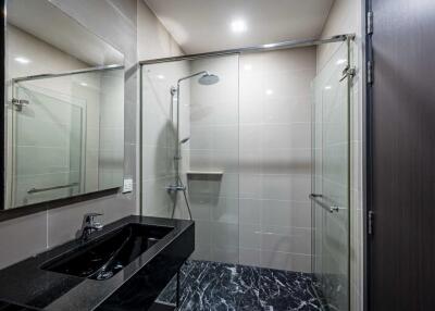 Modern bathroom with shower and black vanity