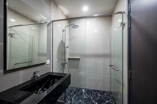 Modern bathroom with shower and black vanity