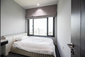 Bedroom with large window and city view