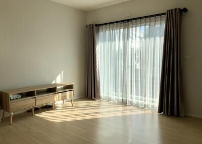 Bright living room with large window and wooden floor