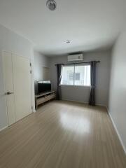 Minimalist living room with wood flooring and natural light