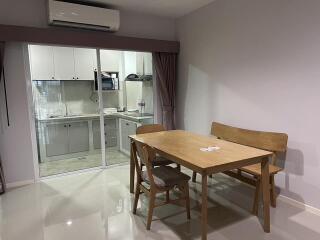 Simple dining area with a table, chairs, and adjacent kitchen