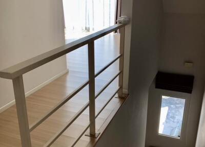 Staircase leading to upstairs living area with bright natural light