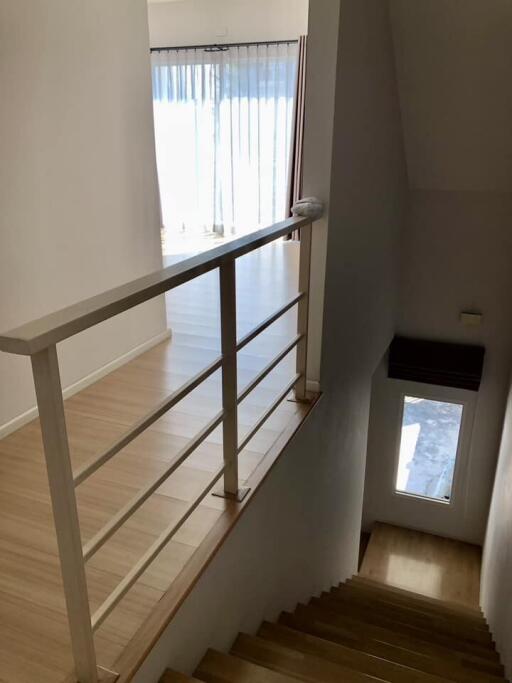 Staircase leading to upstairs living area with bright natural light