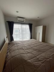 Bedroom with a bed, window with curtains, air conditioner, and wardrobe