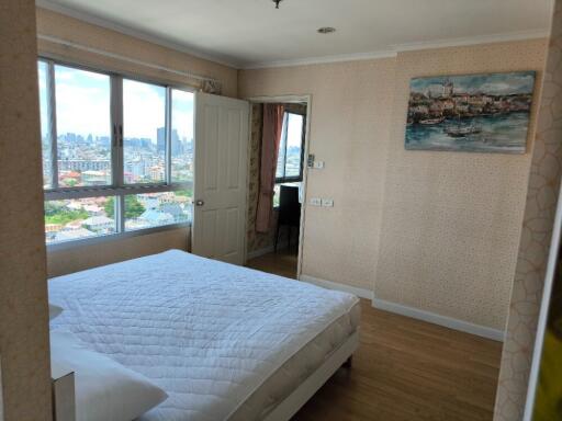 Bright and cozy bedroom with a great city view