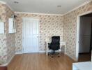 Bedroom with a desk and floral wallpaper