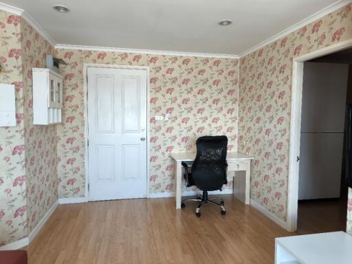 Bedroom with a desk and floral wallpaper