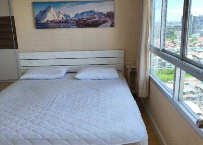 Bedroom with large window and scenic painting