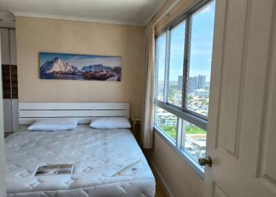 Bedroom with large window and city view